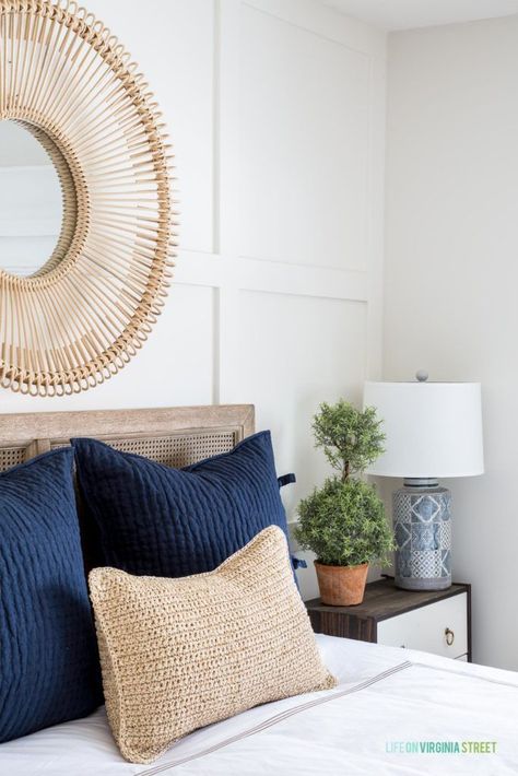 Gorgeous shot of the navy blue throw pillows, textured natural lumbar throw pillow, round rattan mirror, mini topiary tree on the nightstand, and a gorgeous organic feel. Loving this spring guest bedroom! #bedroomdecor #springdecor #sponsored Bedroom Spring, Navy Blue Throw Pillows, Spring Refresh, Master Decor, Coastal Bedroom, Blue Throw Pillows, Guest Bedrooms, Spring Home, White Decor