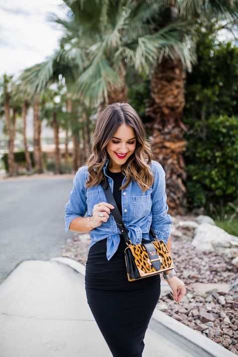 Black fitted midi dress with a chambray shirt tied at the front and a leopard print handbag Denim Shirt Outfit Summer, Denim Shirt Outfits, Shirt Over Dress Outfit, Looks Camisa Jeans, Shirt Over Dress, Svarta Outfits, Chambray Shirt Outfits, Black Fitted Midi Dress, Kemeja Denim