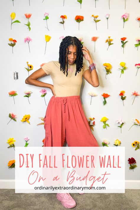 Since my Dollar Tree flower wall was such a hit, I decided just to change our summer flowers for fall ones and leave the pink. I was super scared about peeling the paint as I removed the mounting t… Flower Wall Fall, Flower Wall Backdrop Fall, Dollar Tree Flower Wall, Fall Flower Wall, Fall Wall Flower Arrangements, Teen Bedroom Flower Wall, Pink Fall Leaves, Orange Flower Wall, Flowers For Fall