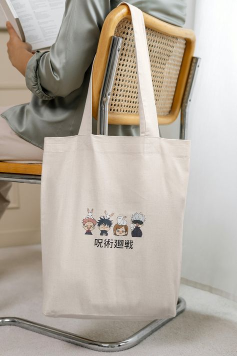 Step into the enchanting realm of Jujutsu Kaisen with our delightful anime tote bag, showcasing the endearing chibi renditions of Yuji Itadori, Megumi Fushiguro, Nobara Kugisaki, and Satoru Gojo. This tote is a must-have accessory for any fan of the anime series. Whether you're off to school, the gym, or a day out with friends, let these beloved anime characters accompany you on your daily adventures. Carry your admiration for Jujutsu Kaisen wherever you go with this charming and practical anime tote bag! -------------------------------------- This 100% cotton tote bag is the perfect way to get started with custom tote bag printing. Add your personality to create a unique daily staple that is as fashionable as is practical.  .: Vibrant color options  .: 100% Cotton .: Extra light fabric (4 My Hero Academia Tote Bag, Chibi Jujutsu Kaisen, Anime Shoulder, Anime Tote Bag, Nobara Kugisaki, Jujitsu Kaisen, Megumi Fushiguro, Yuji Itadori, Fan Accessories