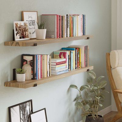 Spruce Up Your Space With 60"x9.5" Hanging BookshelvesFloating book shelf for wall provides you a designated spot to organize books, and neatly display picture frames, fake plants, or home accessories as a part of your home decor. Hanging shelves can be used as floating book shelves for wall to create the perfect reading nook. Our wooden shelves feature an open shelving design that provides a warm and welcoming feel to your living room. | 17 Stories Treston 2 Piece Solid Wood Bracket Shelf Brown Above Tv Bookshelf, Shelves Books Wall, Bookshelves For Wall, Floating Shelf For Books, Bedroom Wooden Shelves, Living Room Wall Bookshelf, Floating Shelves With Books, Floating Bookshelves Bedroom Ideas, Bookshelf Above Desk