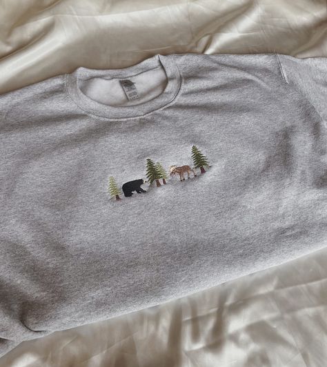 "Embroidered Bear and Moose Sweatshirt -Embroidered on a cotton/polyester blend crewneck sweatshirt, this design is simple and minimalistic, perfect for every outfit! -Embroidery design measures 1.25\" x 5\". -See product pictures for shirt sizing chart. **SWEATSHIRTS ARE IN UNISEX SIZING AND RUN TRUE TO SIZE. -All sweatshirts are handmade on an embroidery machine so there may be slight differences, but we only sell the sweatshirts that meet our high-quality standards. -To maintain the quality o Grey Sweatshirt Embroidery, Cute Sweatshirt Embroidery Ideas, Men’s Embroidered Sweatshirt, Machine Embroidered Clothes, Crew Neck Embroidery Ideas, Cute Embroidery Ideas Shirts, Machine Embroidery Tshirt, Simple Shirt Designs, Embroidery Designs For Shirts