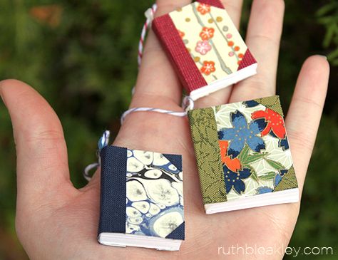 Tiny books to use to make napkin rings or what? Handful of handmade book Christmas tree ornaments by Ruth Bleakley Miniature Book Ornaments, Book Themed Ornaments Diy, Diy Book Ornaments Craft Ideas, Diy Mini Book Ornament, Tiny Book Ornament Diy, Book Themed Ornaments, Diy Mini Christmas Tree Ornaments, Book Theme Christmas Tree, Mini Book Ornaments Diy