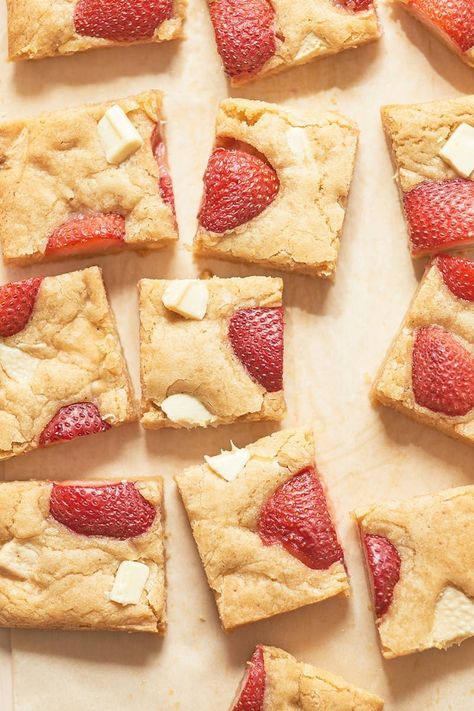 Recipe: Strawberry Blondies | The base is a classic blondie that's been seriously upgraded with the help of brown butter and a slew of chopped white chocolate. Fresh strawberry halves dot the surface — their sweet summer flavor concentrates and caramelizes in the oven, leaving you to bite into juicy, candy-like flavor in between bites of buttery, cookie-like goodness. Strawberry Blondies, Cheesecake Brownie, White Chocolate Recipes, Blondies Recipe, Strawberry Desserts, Desserts To Make, Fresh Strawberries, Sweet Tarts, Strawberry Recipes