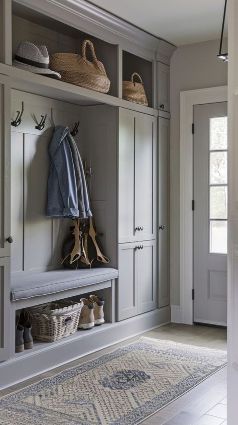 Stylish and functional entryway organization with neutral colors, built-in storage, bench, wicker baskets, and decorative rug. Entryway Organization Ideas, Practical Entryway, Functional Entryway, Utility Room Designs, Mudroom Remodel, Entry Storage, Mudroom Cabinets, Mudroom Makeover, Interior Design Hallway