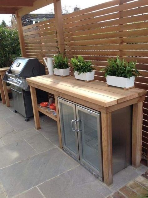 a small outdoor kitchen with a large wooden kitchen island and a drink cooler built in under the top, a grill next to it is cool Design Per Patio, Small Outdoor Kitchens, Small Outdoor Kitchen, Outdoor Kitchen Decor, Outdoor Kitchen Plans, Restaurant Patio, Outdoor Bbq Kitchen, Outdoor Kitchen Ideas, Patio Kitchen