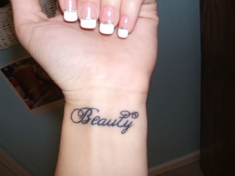 I want this tattoo.   Except i want it to say "beautiful" & on my other wrist i want "hope" The Word Beautiful Tattoo, Word Beautiful Tattoo, Lotus Tattoo Wrist, Cosmetology Tattoos, Couple Wrist Tattoos, Tattoo On Wrist, One Word Tattoos, Cool Wrist Tattoos, Free Tattoo Designs