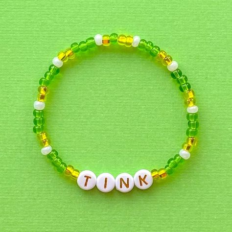 Tink Bracelet Stacking Stretch Bracelet Beaded Bracelet - Etsy Disney Themed Beaded Bracelet, Disney Braclets Ideas, Disney Friendship Bracelet Ideas, Disneyland Bracelets, Friendship Bead Bracelets Ideas, Disney Bracelet Ideas, Disney Beaded Bracelet, Disney Friendship Bracelet, Disney Friendship