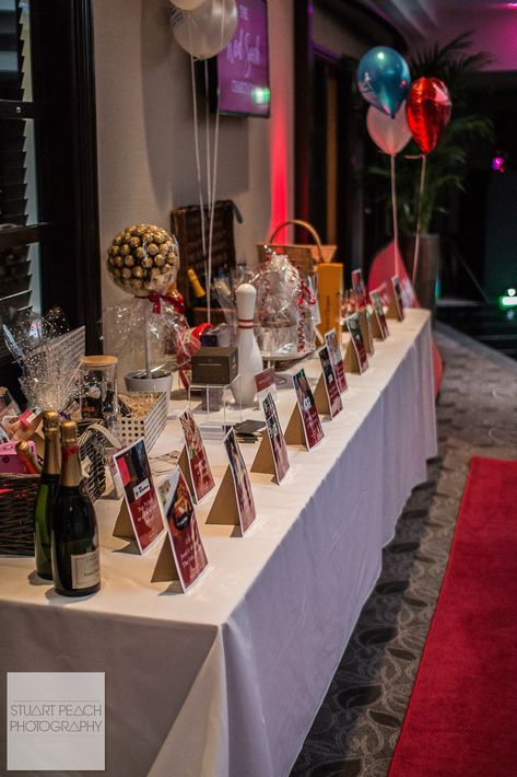 Raffle Prize Display Table @ The Red Sock Gala 2018 #Display #Fundraising #Auction #Raffle Fundraising Table Display, Auction Decorations, Dinner Fundraiser Ideas Silent Auction, Raffle Set Up Ideas, Gala Raffle Ideas, Prize Table Display, Prize Display, Fundraising Decorating Ideas, Silent Auction Set Up