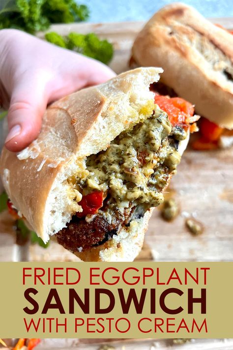 Two halves of a Fried Eggplant Sandwich with Pesto Cream, one half held toward the camera by a hand Eggplant Panini Recipes, Artichoke Parm Sandwich, Eggplant Pesto Recipes, Fried Eggplant Sandwich, Eggplant Sandwich Recipes, Poolside Sandwiches, Eggplant Parm Sandwich, Pesto Cheese Sandwich, Sandwich With Pesto