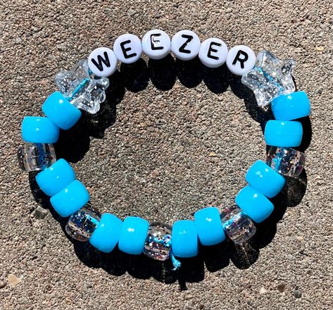 Weezer inspired kandi bracelet perfect to wear for a weezer concert ;) Variations are options now, too many people were putting down very wrong sizes in personalization, if you have a question about the size contact me ASAP, I tend to ship out very quickly! please remember bracelets like these are elastic so they will be able to accommodate for a bigger wrist :)  sizes are in inches measured around the wrist , not along the top of the wrist Weezer Kandi Cuff, Band Kandi Bracelets, Pierce The Veil Bracelet, Weezer Bracelet, Funny Kandi Bracelets, Weezer Concert, Funny Bracelets, Kandi Inspiration, Scene Kandi