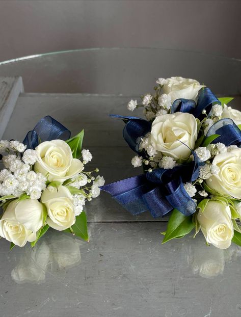 Wrist corsage and boutonniere pair of white spray roses, babies breath and navy blue ribbon. 

Orange Florist | Flower Delivery by The Dizzy Daisy
#thedizzydaisy #floral #bridal #weddings #weddingfloristOC #ocweddings #orangecountyweddings #orangecounty #bridalparty #bridesmaids #groom #groomsmen #weddingday #weddinginspiration #love #inlove #ido #weddingflowers #weddingideas #justmarried #chic #trends #elegant #beautiful #corsage #boutonniere #wristcorsage White Corsage And Boutonniere, Navy Blue Corsage, Prom Flowers Corsage, White Corsage, Blue Boutonniere, Homecoming Corsage, White Spray Roses, Boutonnieres Prom, Corsage And Boutonniere Set