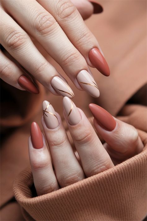 Embrace the season with these chic fall nail ideas that exude a sophisticated yet understated vibe. This Autumn simple design features a warm terracotta base adorned with delicate leaf patterns in muted gold and rust. Perfect for any occasion, these nails capture the essence of fall while remaining effortlessly stylish. Elevate your nail game this autumn with this stunning look! #FallNailIdeas #AutumnNails #NailArt #SeasonalStyle Nails To Match Rust Color Dress, Terracota Nails Ideas, Rust Color Nails Designs, Rust Nail Color, Terracotta Nails Designs, Rust Nails Design, Earth Tone Nails Designs, Simple Fall Nail Ideas, Simple Fall Nails Autumn