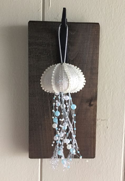 Jellyfish Christmas ornament made from a sea urchin shell. Sea Urchin Jellyfish Ornament Diy, Crafts With Sea Urchin Shells, Urchin Shell Crafts, Jellyfish Christmas Ornaments Diy, Jellyfish Ornament Diy, Sea Urchin Jellyfish, Sea Urchin Decor, Sea Urchin Crafts, Sea Urchin Shell Crafts