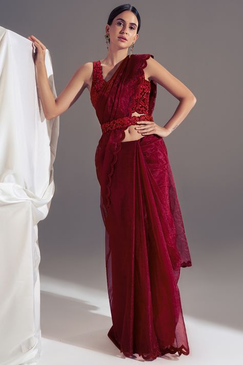 Featuring a deep red saree in organza base with a scalloped embroidery. It is paired with a matching suede embroidered blouse and a corset belt.  FIT: True to size. COMPOSITION: Suede, Organza. CARE: Dry clean only. Deep Red Saree, Scallop Saree, Red Organza Saree, Farewell Saree, Floral Sarees, Maroon Saree, Simple Saree Designs, Simple Sarees, Elegant Blouse Designs