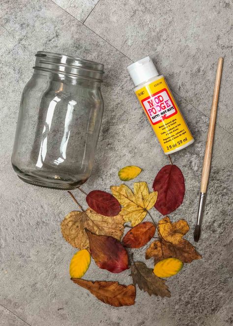 Easy leaf mason jar lanterns nature craft - Growing Family Fall Mason Jar Crafts Tea Lights, Pressed Flower Jars, Crafts With Fall Leaves, Leaf Lantern Craft, Waldorf Festivals, Recycled Candle Jars, Seasons Craft, Leaf Mason Jar Candle, Fall Mason Jar Crafts