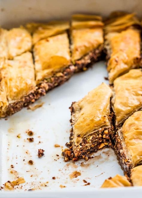 This Chocolate Baklava is one of my favorite desserts. Sweet, crisp and buttery layers of phyllo filled with pistachios, walnuts, almonds, hazelnuts and Nutella, baked to perfection then drizzled with a sweet honey syrup. www.jocooks.com #baklava Steakhouse Desserts, Chocolate Baklava, Phyllo Recipes, Baklava Recipe, Shortcake Recipe, Egyptian Food, Honey Syrup, Yogurt Recipes, Köstliche Desserts