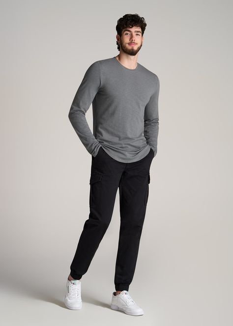 About Our Slub Long Sleeve Scoop Tall Men's Tee If you need to stock up on essentials, don’t miss out on this tall long sleeve shirt. It’s made with a stretch-infused cotton slub jersey that has a slightly textured yet supremely soft finish. The close fit is designed to sit next to the body and makes this an ideal layering or lounging piece. We made this extra long top with a scooped hem for a classic menswear feel that looks good on its own or under a sweater. This tee lands at the hip and has Very Tall Man, Tall Mens Outfits, Tall Men’s Fashion, Slim Guys Fashion Outfit, Relaxed Fit Outfit Men, Outfits For Tall Guys, Big And Tall Fashion For Men, Beckham Outfit, Mens Winter Wardrobe