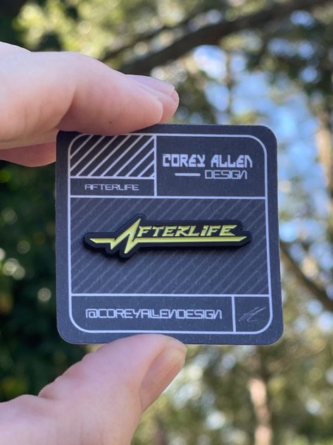 "Afterlife club sign from the CDPR Game \"Cyberpunk 2077\" * 1.5\" soft enamel pin * Double posts on the back of pin to secure it and keep it from rotating.  * Black metal finish  * Comes mounted on a backing card packaged inside of a celophane bag for protection and gifting.  Follow on Instagram for updates!  @CoreyAllenDesign" Cyberpunk Club, Laser Products, Bear Mask, Pin Card, Soft Enamel Pins, Animation Art Character Design, Backing Card, Art Station, Soft Enamel