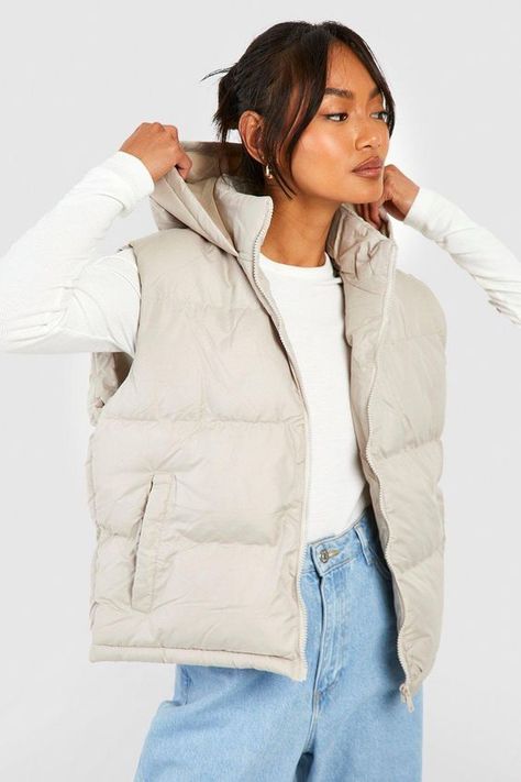 Womens Hooded Vest - Beige - 10 - Add a different type of layer to your look with this vest, a sporty and stylish piece. This sleeveless jacket closely resembles a waistcoat and is perfect for throwing over long sleeve tops, sweaters, and lightweight coats. This body warmer can add that much-needed extra insulation to your outfit during colder months without making you feel too bulky. Style this women's vest with a sports outfit, work attire, or everyday look.Style: GiletFabric: PolyesterNecklin Sleeveless Jacket Outfit, Womens Hooded Vest, Puffer Outfit, Beige Puffer, Waistcoat Designs, Hooded Gilet, Faux Fur Gilet, Sports Outfit, Outfit Work