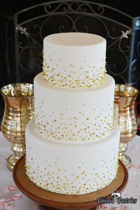 This simple wedding cake becomes the star of the show with the addition of subtle gold beads on each tier. Cakes with understated but elegant decor are perfect for weddings in any season. #EloisesPastries #bakery #weddingcake #weddings #cake #gold #weddingseason Gold Anniversary Cake, Golden Wedding Cake, Golden Wedding Anniversary Cake, 50th Wedding Anniversary Decorations, 50th Wedding Anniversary Cakes, 50th Anniversary Cakes, Tier Cakes, Spring Wedding Cake, 50th Wedding Anniversary Party