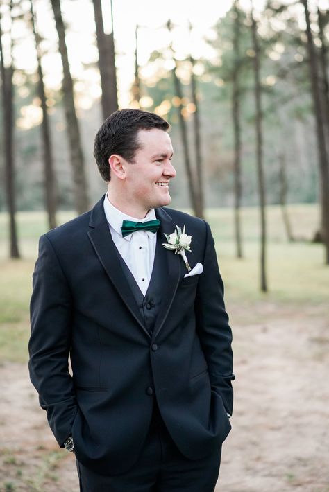 | groom in a black tux | winter groom ideas | groom in black tux with dark green bow tie | christmas wedding ideas | classy winter wedding ideas | winter wedding style | groom accessories | groom's look | groom in black | classy groom | classy wedding | photo taken at THE SPRINGS Event Venue. follow this pin to our website for more information, or to book your free tour! SPRINGS location:  Pine Hall in Lake Conroe, TX photographer:  Caitlin Rose Photography #groom #winterwedding #weddingstyle Black Tux With Emerald Green Bow Tie, Black Tux With Green Bow Tie, Black Suit With Green Bow Tie, Black Tux Green Bow Tie, Black Suit Green Bow Tie, Black Tux With Green Tie, Debut Court, Winter Groom, All Black Tux