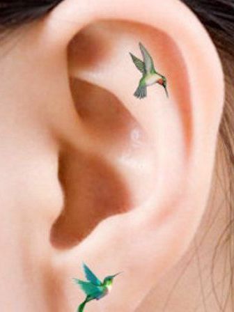 Small Hummingbird Tattoo Behind Ear, Fairy Ear Tattoo, Hummingbird Ear Tattoo, Tiny Hummingbird Tattoos For Women, Small Ear Tattoos For Women, Dainty Ear Tattoos, Helix Tattoo Ideas, Ear Tattoos Women, Dainty Hummingbird Tattoo