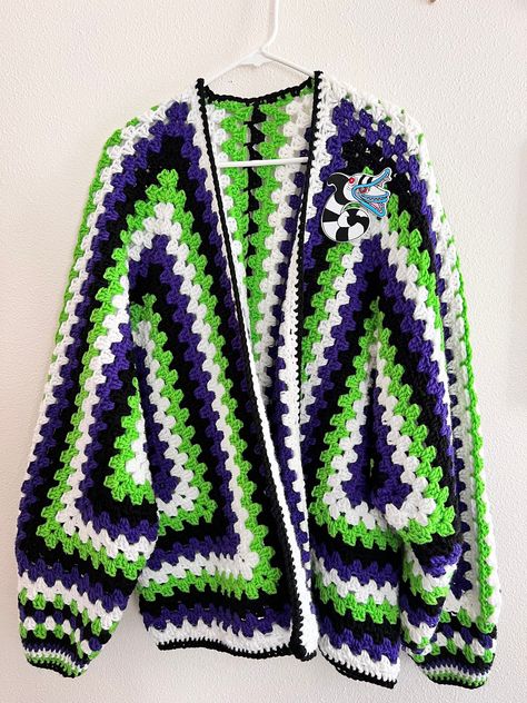 Hexi Cardi - colors inspired by Beetlejuice  Crochet Hexagon Granny Square Cardigan handmade by me! Takes me 40 hours to complete. This is a size X-Large.  Arm length from armpit to wrist is 19 inches  Length from top to bottom 28 1/2  inches  back armpit to armpit 27 1/2 inches if you would like the patch added to the Cardi please send me a message once ordered.  Made from 100% acrylic yarn. Hand wash or machine was in delicate cycle and lay flat to dry. Ready to ship 📦 Beetlejuice Granny Square, Plus Size Granny Square Cardigan, Crochet Beetlejuice Cardigan, Hexicardigans Crochet, Skull Granny Square Cardigan, Crochet Beetlejuice Pattern Free, Halloween Crochet Cardigan, Beetle Juice Crochet, Crochet Hexagon Granny Square