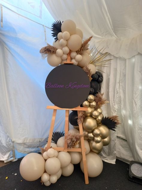 Balloon Garland For Welcome Sign, Easel And Balloon Garland, Balloon Arch With Sign, Pampas Grass Balloon Garland, Easel Sign With Balloons, Balloon Garland On Easel, Easel With Balloon Garland, Balloons Around Easel, Balloon Easel Display