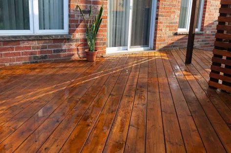 11 Deck Stain Colors That Will Make Your Deck Pop! 12 Outdoor Wood Stain Colors Decks, Stain Colors For Wood Deck, Patio Deck Stain Ideas, Wood Porch Stain Ideas, Porch Floor Stain Colors, Stains For Decks Wood, Sw Banyan Brown Stain, Deck And Fence Stain Ideas, Deck Stain Red Brick House