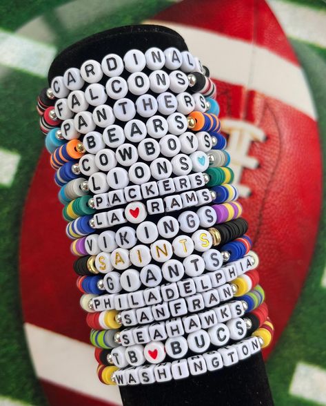 Handmade Bracelet-Ships from Upstate New York!  🏈Support your favorite NFL team with this personalized bracelet! 🏈This listing is for ONE bracelet, which includes clay beads matching your team's colors, white cubes with black letters, and one silver bead. Personalize it with any word or name you would like. 🏈For stack of 3 bracelets, please order through this link: https://www.etsy.com/listing/1745570066/kansas-city-chiefs-stack-bracelet-chiefs 🏈To order an all silver or all gold beaded bracelet to stack, please order through this link: https://www.etsy.com/listing/1749519192/goldsilver-bead-bracelet-gold-bead 🏈Standard letter beads are white with black lettering, either round or cube. Other letter options may be available such as white with gold or colored; feel free to inquire when Football Team Bracelets, Football Clay Bead Bracelets, Messi Bracelet, Braclets Diy, Sports Fan Accessories, Fan Bracelet, Team Bracelets, Football Bracelet, Stack Bracelet