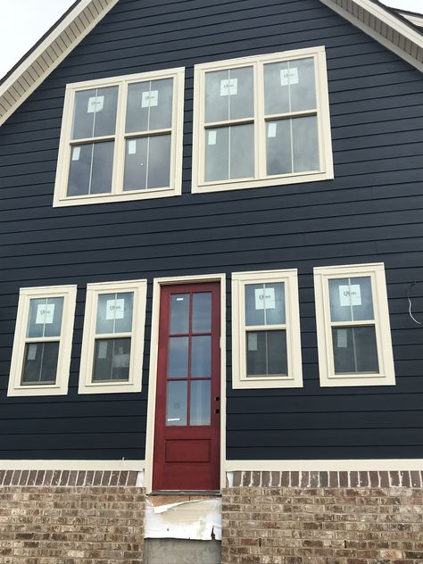 Brigand navy paint and CrabbyApple Sherwin Williams red door Red Accent House Exterior, Blue Gray Exterior House Colors Red Door, Navy House Red Door, Blue Siding Red Door, Dark Blue House Red Door, Navy Blue House With Red Door, Red Door Blue House, Black House Red Door, Navy House Door Color