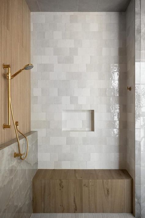 A brown teak shower bench is fixed against gray brickwork square tiles under a gray tiled niche. Bathroom With Sitting Bench, Shower Ledge And Bench, Square Tile Bathroom Walls, Niche Above Shower Bench, Square Subway Tile Bathroom, Offset Square Tile, Shower Bench Ideas Built Ins, Master Shower With Bench, Tiled Shower Bench