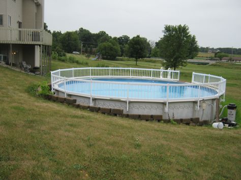 retaining wall around above ground pool | Columbia City house now connected to pool with new decks Above Ground Pool Inground, Pool Retaining Wall, Pool Deck Ideas Inground, Patio Edging, Pool Deck Plans, Swimming Pool Decks, Columbia City, Sloped Backyard, Swimming Pool House