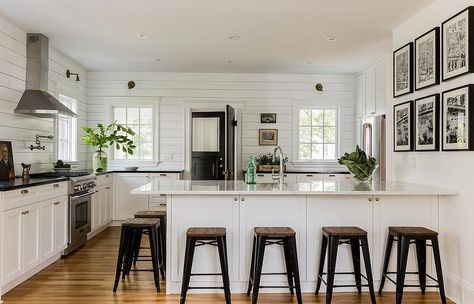 Black and white cottage kitchen features a white shaker cabinets paired with honed black countertops and a horizontal shiplap backsplash. Horizontal Shiplap, White Cabinets Black Countertops, White Cottage Kitchens, Shiplap Kitchen, Cottage Kitchen Cabinets, Shiplap Backsplash, Black Countertops, White Shiplap, Cottage Kitchens