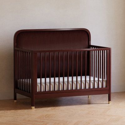 The Brimsley Tambour crib is a masterpiece of craftsmanship that blends timeless design with modern functionality. Its distinctive tambour design and gently curved slats, paired with elegant gold feet, make this crib more than just a place for your little one to rest. It's a statement piece that elevates the aesthetic of your nursery.​ Color: Crimson Namesake Brimsley Tambour 4-in-1 Convertible Crib - Cribs in Crimson | Size Standard | Birch Lane Red Crib, Dark Nursery, Brown Crib, Mid Century Nursery, Nursery Color, Red Nursery, Wood Crib, Nursery Room Design, Nursery Office