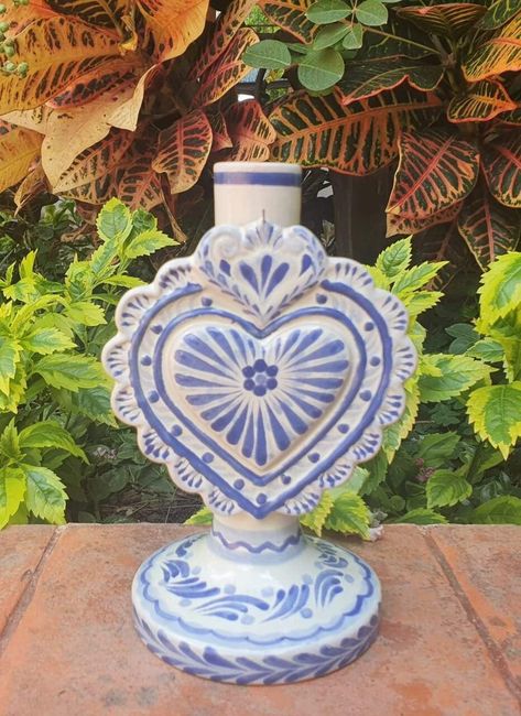 LOVE HEAR CANDLE HOLDER 4.3in W  X 5.1in L  X 7.7in H 11cm A  X 13cm L  X 19.5cm Alt Internationally recognized and Award Winner Gorky Gonzalez and his workshop have dedicated their work to rescue the traditional majolica of Guanajuato, Mexico.   Each piece is carefully handcrafted. Lead Free handcrafts handmade Mexico visit our website to see more pieces https://gorkygonzalez.com/collections/mexican-pottery-saints-collection Mexican Candles, Mexican Pottery Decor, Garden Gate Ideas, Blue Talavera, Talavera Art, Hacienda Decor, Talavera Design, Heart Candle Holder, Hacienda Wedding