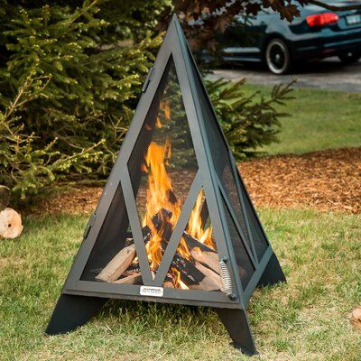 Perfect for an urban patio, the 3' Pyramid Outdoor Fireplace combines a stainless steel spark screen with a heavy-duty fire bowl in a unique pyramid shape. One side is hinged to allow the wood to be added to the fire. | Iron Embers Steel Wood Burning Fire Pit black/Brown/gray 48.0 x 32.8 x 32.8 in | IREM1008_46828012 | Wayfair Canada Welded Furniture, Steel Fire Pit, Burning Fire, Wood Burning Fire Pit, Fire Pit Designs, Steel Wood, Fire Bowls, Stainless Steel Mesh, Outdoor Fireplace