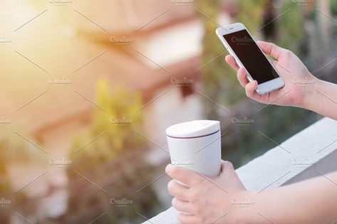 Hand holding phone and thermos mug by Nuchylee Photo on @creativemarket Shopping Healthy, Hand Holding Phone, Holding Phone, Woman Shopping, Technology Photos, Mobile Smartphone, Mobile Learning, Paying Bills, Blurred Background