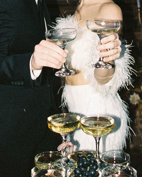 Champagne tower, vintage wedding, vintage wedding inspiration, coupe glasses, bows, bows on glasses, feather wedding dress, feather dress, champagne tower with fruit, champagne tower with grapes, anti bride, vintage wedding aesthetic, old hollywood aesthetic, hollywood wedding aesthetic Luxe Vintage Aesthetic, Wedding Catering Aesthetic, Old Holly Wood Aesthetic, Glitz And Glam Holiday Party, Champagne Dress Aesthetic, 1920s Glamour Aesthetic, Old Hollywood Mood Board, Hollywood Party Aesthetic, Couple Champagne Photo