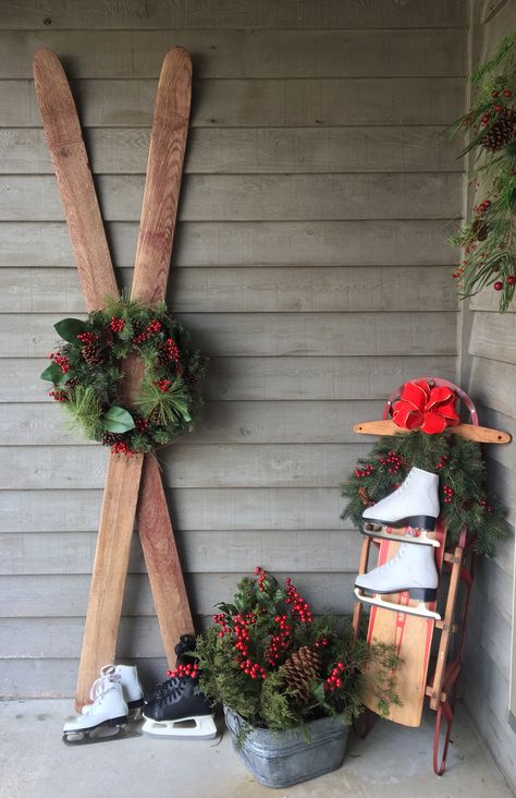 Christmas porch decor includes old skis, sled, skates and winter greenery with red bow, galvanized tub with fresh cut cedar and pine cones Vintage Remodel, Easy Outdoor Christmas Decorations, Christmas Sled Decoration, Sled Decor, Outdoor Christmas Diy, Old Skis, Christmas Sled, Ski Decor, Winter Greenery