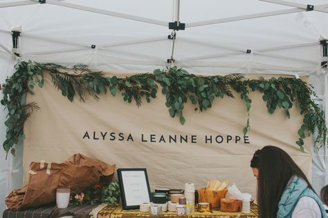 Alyssa Leanne Hoppe's garland workshop with gorgeous hanging greenery and printed banner. Craft Fair Booth, Market Stall Display, Art Fair Booth, Vendor Booth Display, Craft Fair Booth Display, Christmas Booth, Craft Show Booths, Stand Feria, Craft Market Display