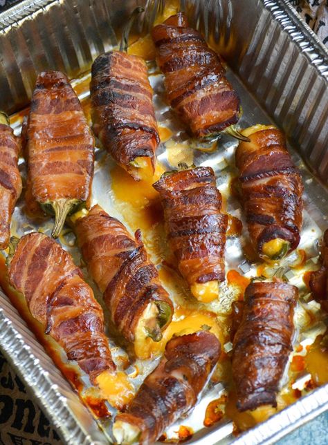 bacon wrapped smoked jalapeno poppers shown in a disposable aluminum tray Bacon Wrapped Jalapenos In Smoker, Smoked Bacon Wrapped Jalapenos, Smoked Jalapeno Peppers Bacon Wrapped, Jalapeno Bacon Wrapped, Smoked Jalapeno Poppers, Sausage Stuffed Jalapenos, Bacon Wrapped Stuffed Jalapenos, Trager Grill, Cheesy Snacks