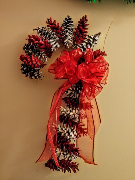 The wreath form and ribbon were from Dollar Tree and the paint was from Walmart. The pine cones are from my yard! Complete for under 5 dollars!! Red Pine Cones, Christmas Wreaths With Pine Cones, Candy Cane Pine Cone Wreath, Pinecone Candy Cane, Pine Cone Candy Cane, Pinecone Candy Cane Wreath, Pine Cone Candy Cane Wreath, Pinecone Wreath Christmas, Pine Cone Wreath Ideas