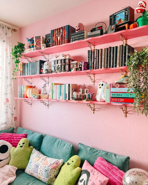 bet ya didn’t know i’d end up painting the shelves pink 😅🤭 we still need touch up some paint on the bottom of the shelves, but this was the last wall in my library that needed to be worked on & we basically finished it last night! my whole library is now officially done (for now lmao) & looks so fun from every angle 😭 spending time in here heals me 💞 its full of all of my favorite things & that’s so cool?? i have books, legos, a cozy gaming setup, puzzles, a comfy reading spot, a bookshelf... Pink Library Aesthetic, Barbie Bookshelf, Shelf Behind Couch, Small Home Library Ideas, Pink Library, Cozy Gaming Setup, Small Home Library, Game Shelf, Den Design