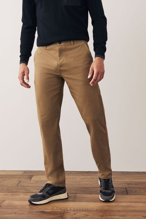 A wardrobe staple; our versatile chino trousers are made from a cotton stretch fabric for comfort and style all in one. Designed in a classic chino silhouette, they look great dressed up or down. With two functional back pockets, our variety of fits, colours and leg lengths ensure you can find your perfect match. Also available with a modern update; our elasticated waist styles offer an adjustable fit that's right for you, and our pleat chinos offer choice in an everyday classic. Machine washabl Tan Chinos Men Outfits, Pre Apocalypse, Khaki Trousers Outfit, Chinos Men Outfit, Chinos Men, Tan Chinos, Mens Trousers Casual, Mens Chino Pants, Blue Chinos