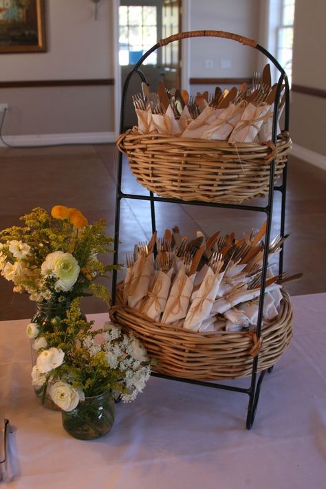 another inexpensive way to wrap utensils in napkins in this two tiered basket on buffet table Cutlery Decoration Party Ideas, Utensil Holder For Wedding Reception, Good Buffet Display, Table Settings For Mens Birthday, How To Set Buffet Table, Wedding Shower Buffet Table Ideas, Wedding Utensil Holder, Cutlery Party Display, Utensil Party Display