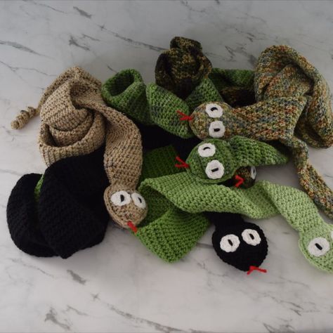 This snake scarves have been restocked. These scarves are perfect for the snake lovers out there. It is cute, fun and very warm. It is double thick and the snakehead is slightly stuffed with polyfill. The snake scarves are approximately 57 " long and approx 3' wide. Snake Scarf, Crochet Snake, Snake Lovers, Scarf Crochet, Scarf Crochet Pattern, The Snake, Crochet Scarves, Make And Sell, Crochet Patterns