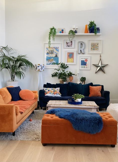 Blue Couch White Walls Living Room, Orange Ottoman Living Room, Blue Couch Orange Rug, Navy And Orange Living Room Decor, Orange And Blue Apartment, Pink Blue Orange Aesthetic Living Room, Navy Blue Mustard Yellow Burnt Orange Living Room, Dark Blue And Orange Living Room, Blue And Orange Lounge