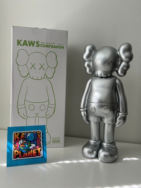 This Kaws Companion Open Edition Vinyl Figure in Silver is a must-have for any action figure collector. Made from high-quality vinyl material, it features a sleek silver color that adds a touch of sophistication to your collection. The figure is perfect for display on shelves or desks, and is sure to draw attention from friends and family alike. The figure is great for those who love Kaws art, and is a perfect addition to any collection. Kaw Figurines, Kaws Companion, Vinyl Figures, Action Figure, Doll Toys, Silver Color, To Draw, Action Figures, Art Collection